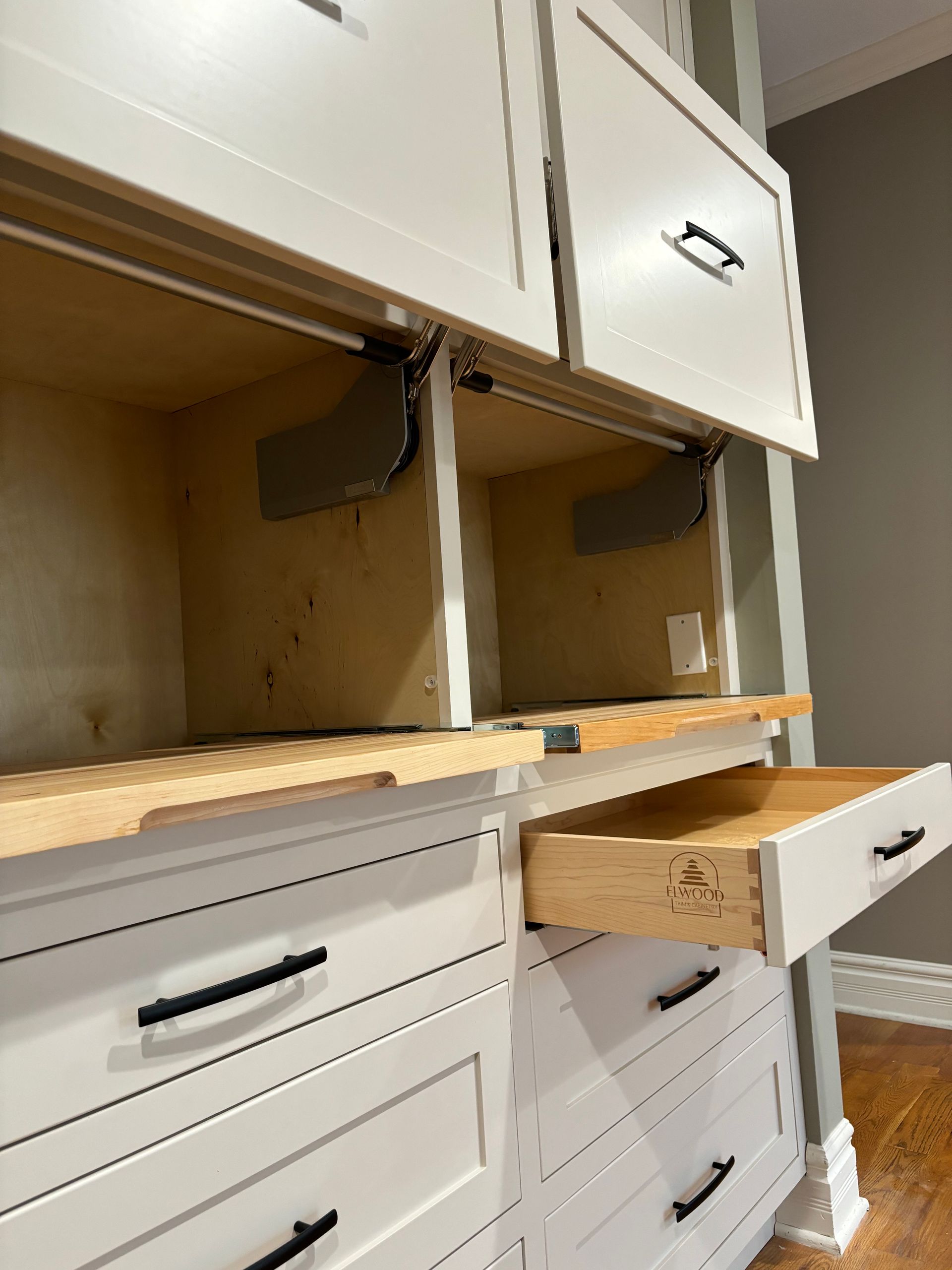 White cabinet unit with open doors, drawer, and exposed interior.