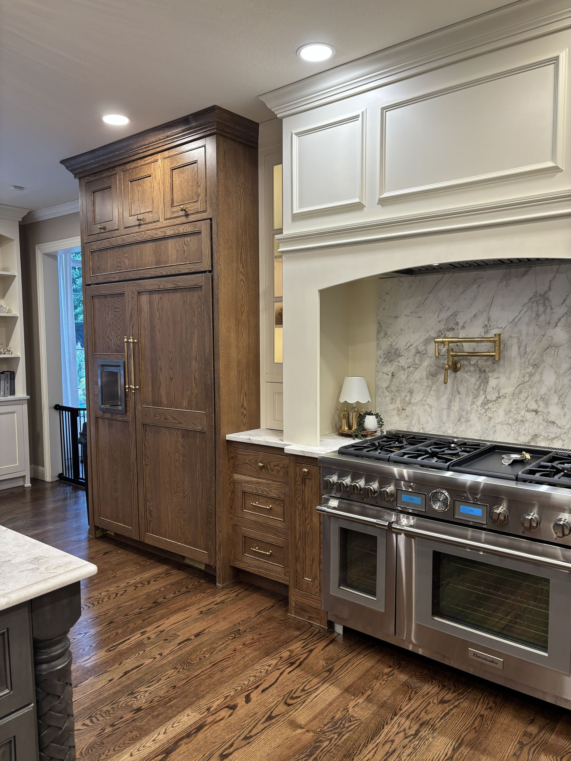 Kitchen with brown cabinets, stainless steel stove, and white countertop.