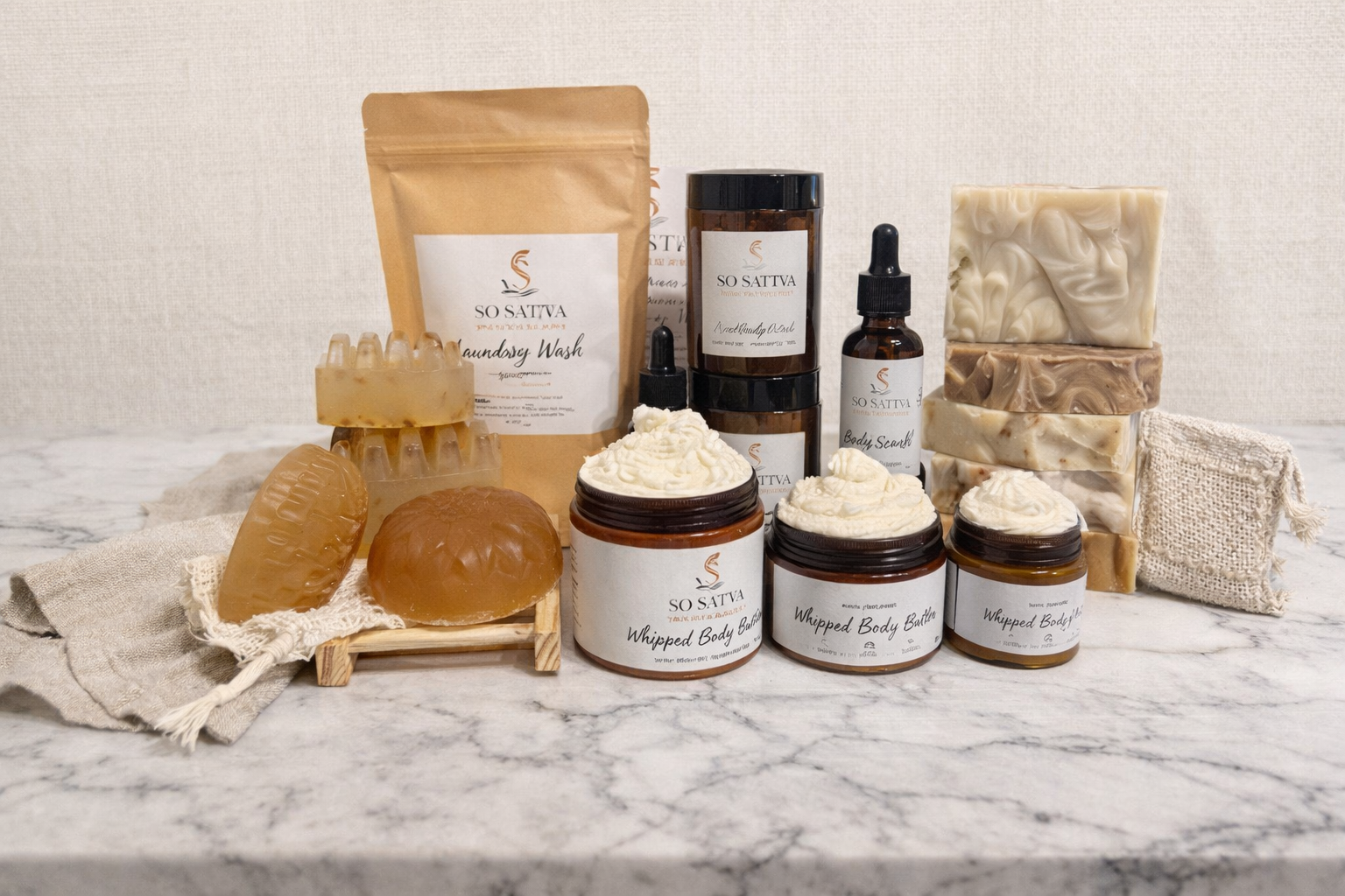 A collection of various skincare and bath products, including jars, soaps, and a scrub pouch on a marble surface.