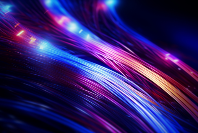 Glowing fiber optic cables in shades of blue, purple, and orange against a dark background.