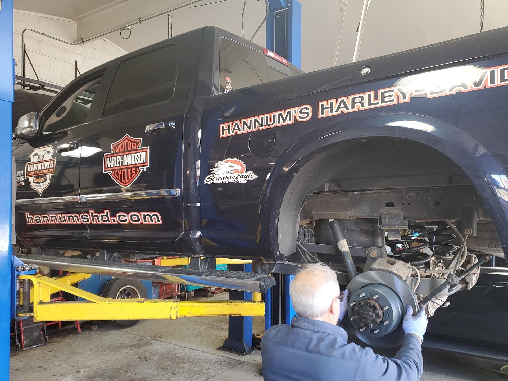 Mechanic working on the rear wheel of a truck with 