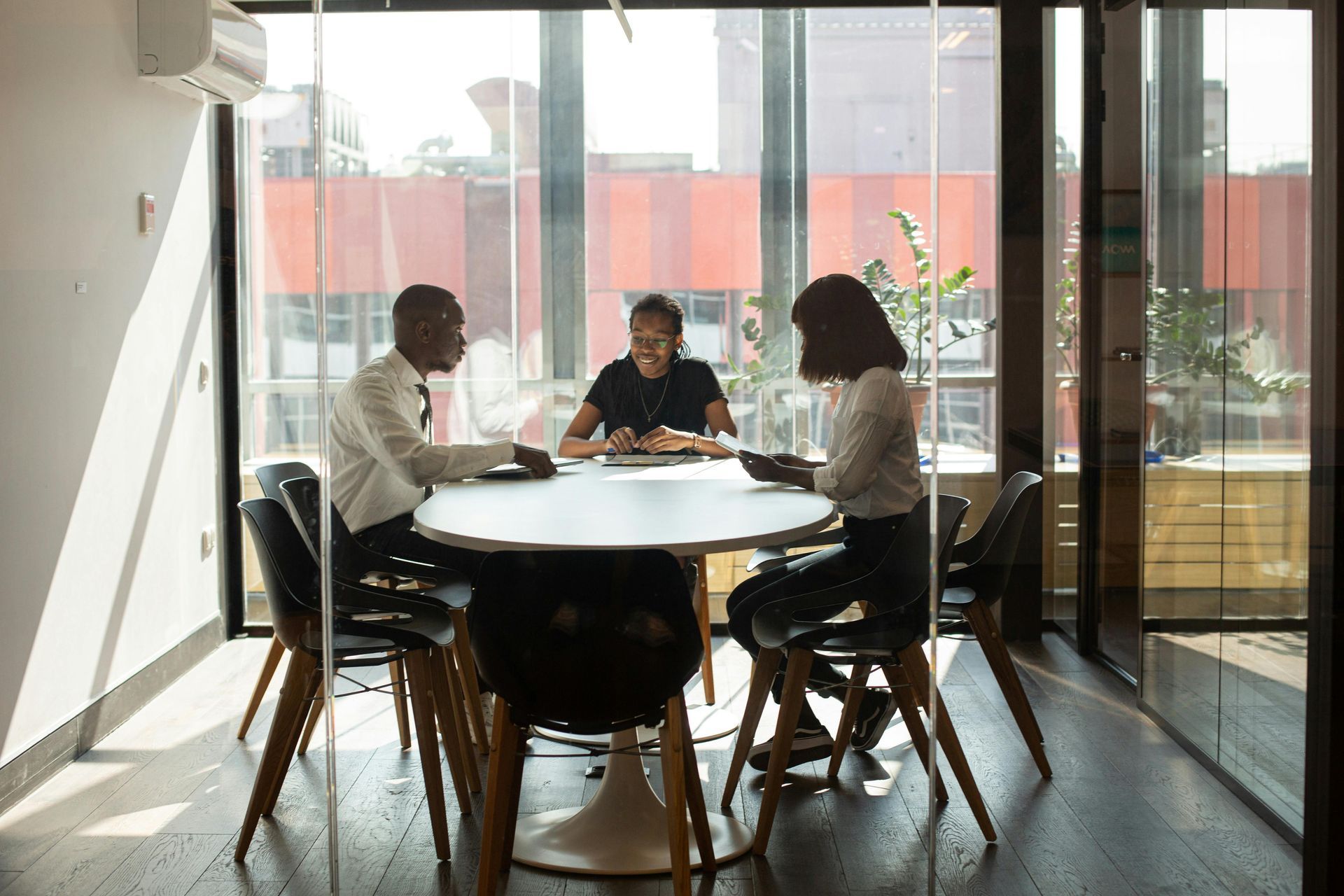 a lawyer meeting with lients at a round table, dscussing a document