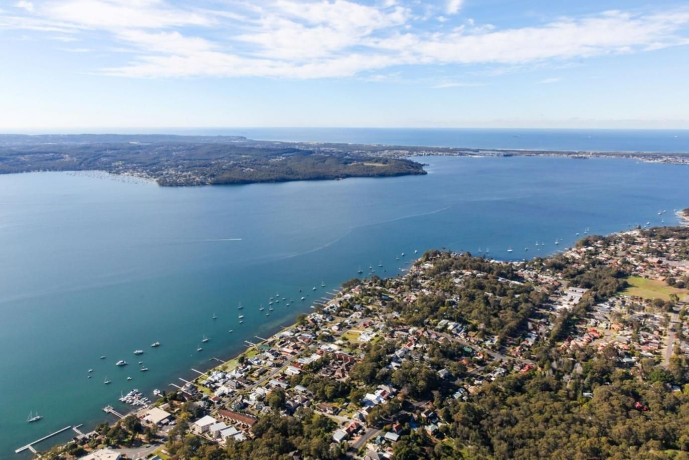 An Aerial View of A Large Body of Water with A Small Island — Hayden Tree Service In Toronto, NSW