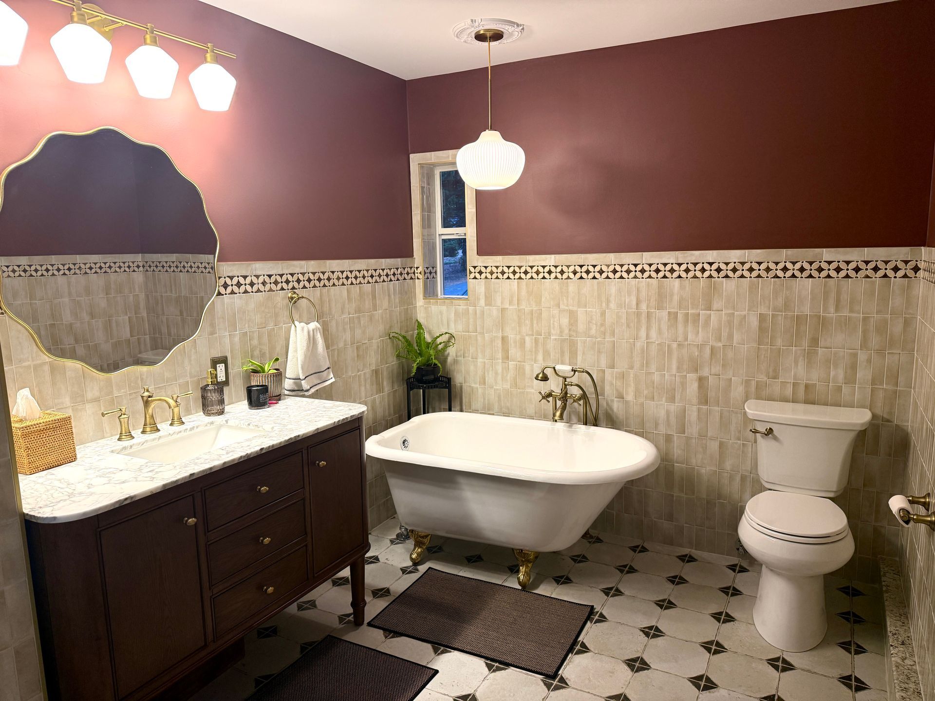 A bathroom with a toilet, steam shower, clawfoot tub with exquisite tile.