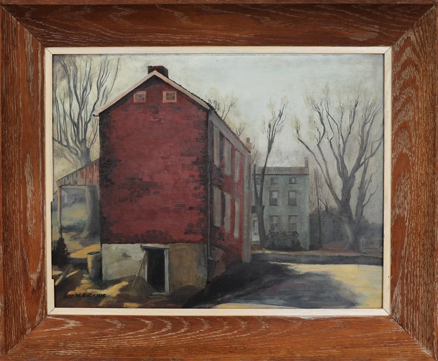 Framed painting of a red brick house and leafless trees on a quiet street