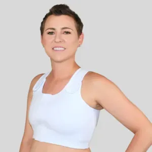 Smiling person in a white sleeveless top against a gray background