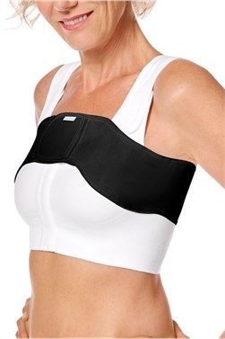 Woman wearing a black-and-white sports bra with a black shoulder brace strap