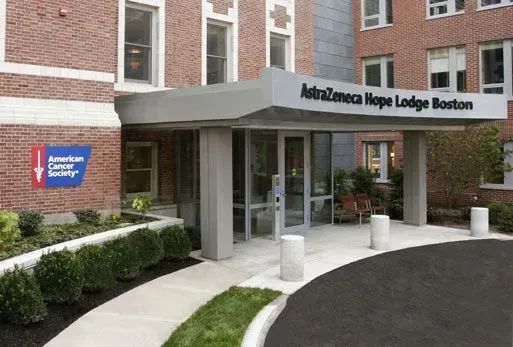 Main entrance of the American Cancer Society Hope Lodge Boston, with brick building and covered drop-off area