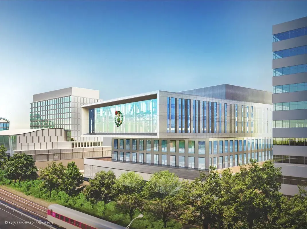 Modern glass office building complex with trees and a blue sky background