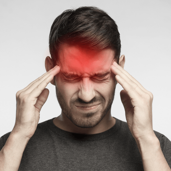 A man is holding his head because he has a headache
