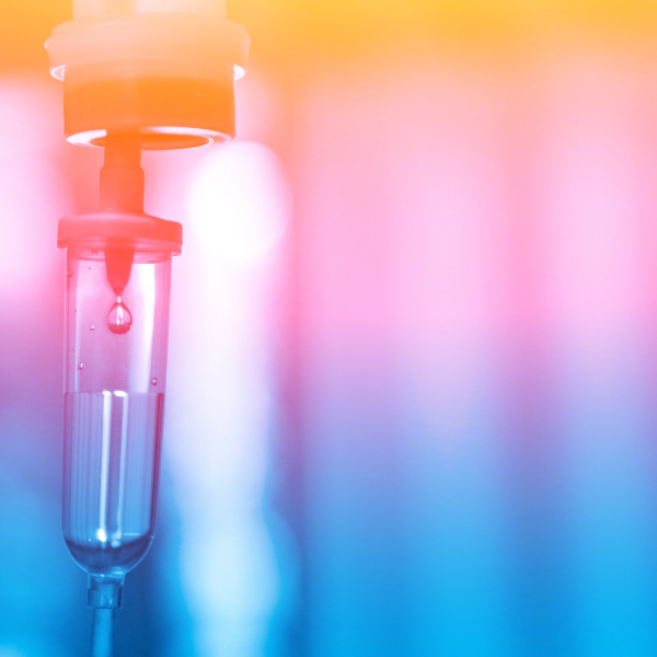 A close up of an iv drip with a drop of liquid coming out of it.