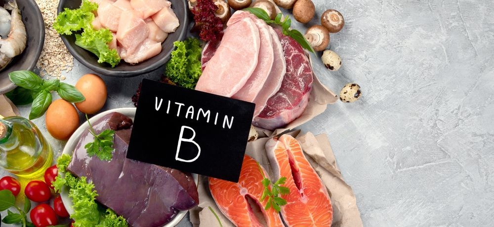 A variety of foods containing vitamin b are displayed on a table.