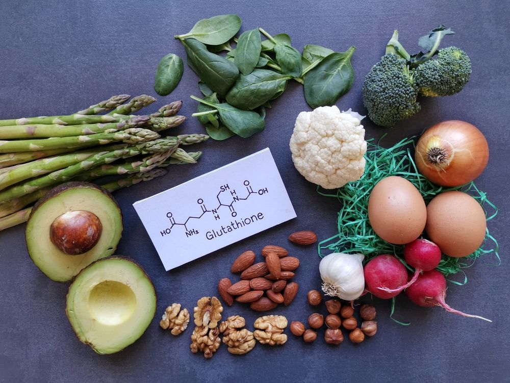 A variety of vegetables and nuts are laid out on a table.