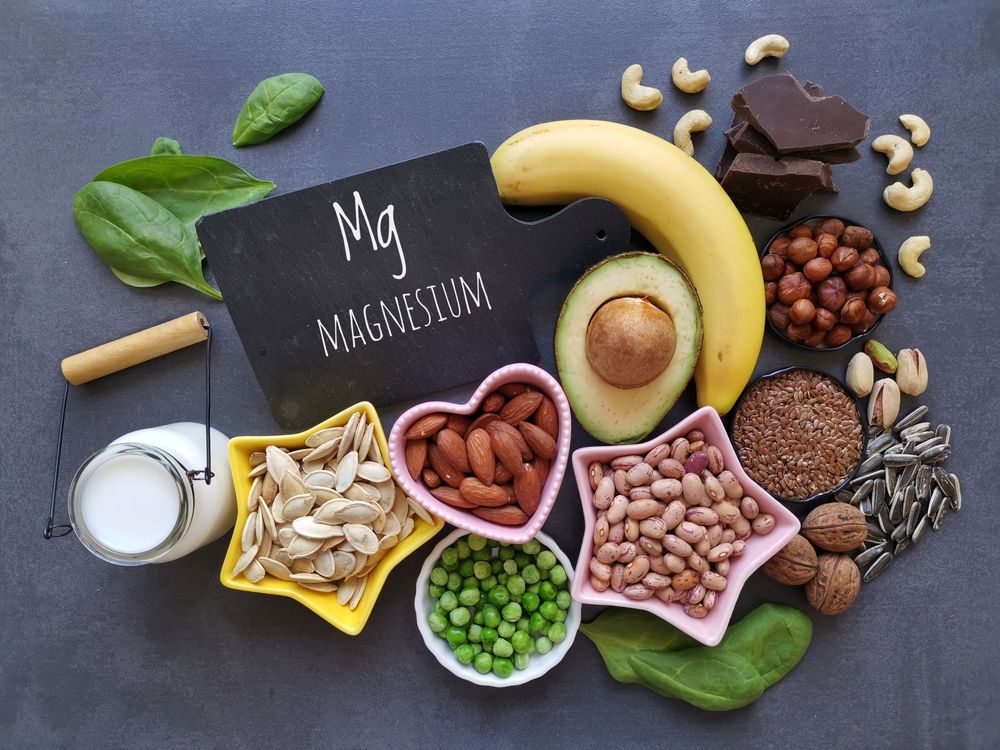 A variety of foods containing magnesium are on a table.