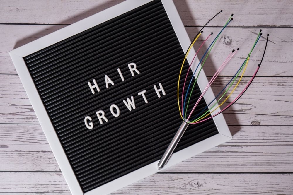 A letter board with the words `` hair growth '' written on it.