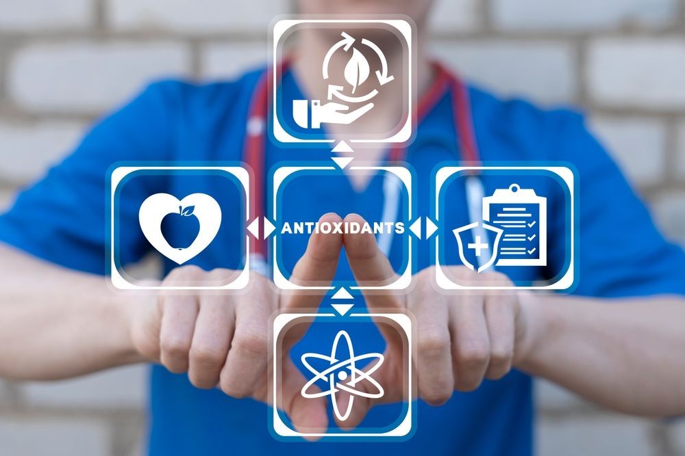 A nurse is holding a display of antioxidants in her hands.