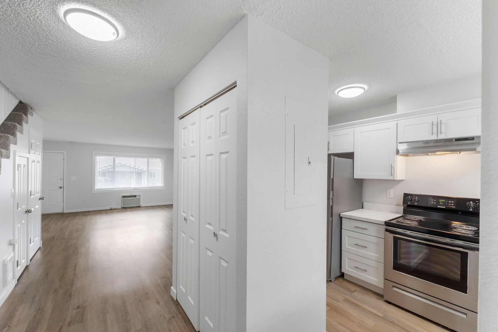 A kitchen with stainless steel appliances and white cabinets