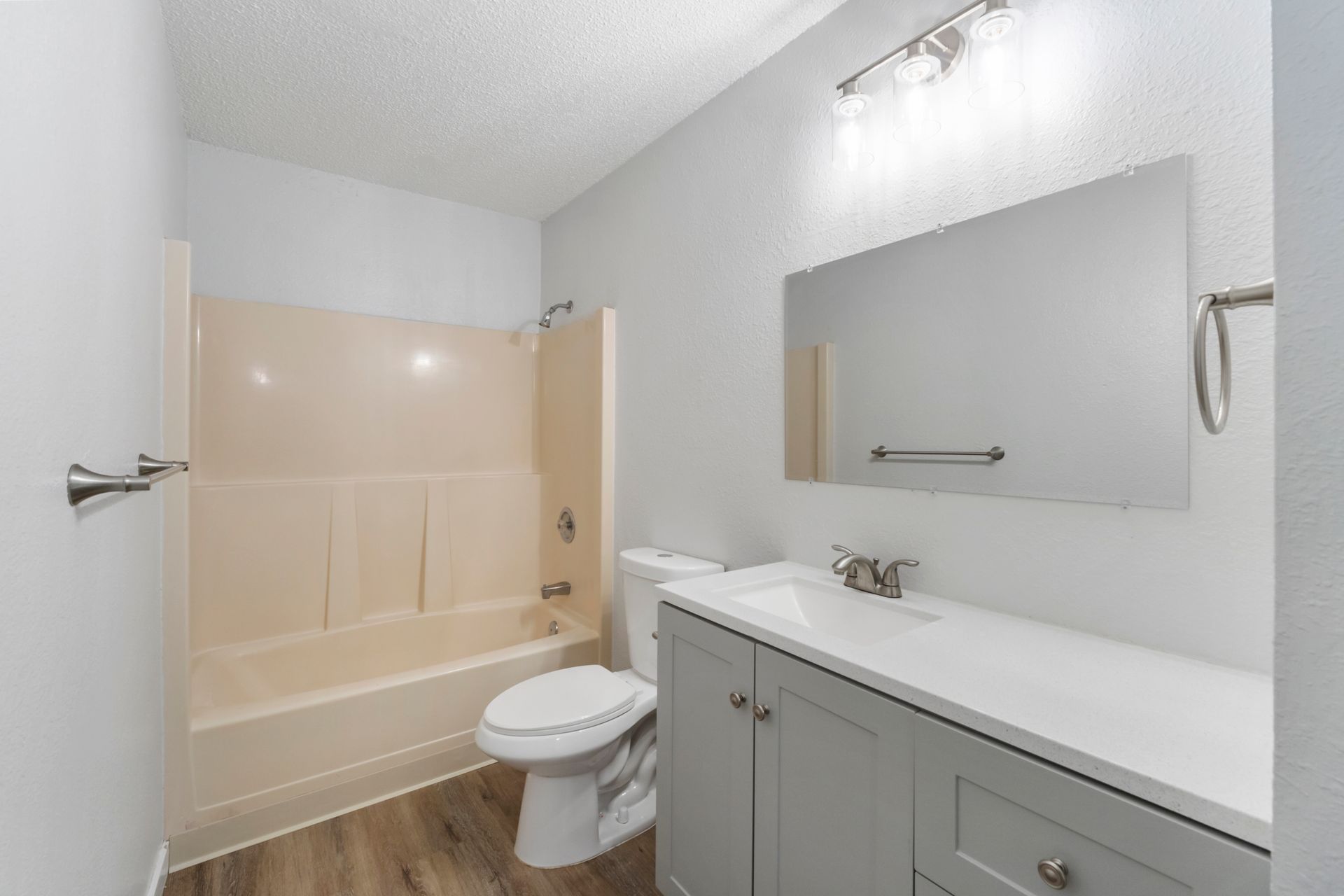 A bathroom with a toilet , sink , and shower.