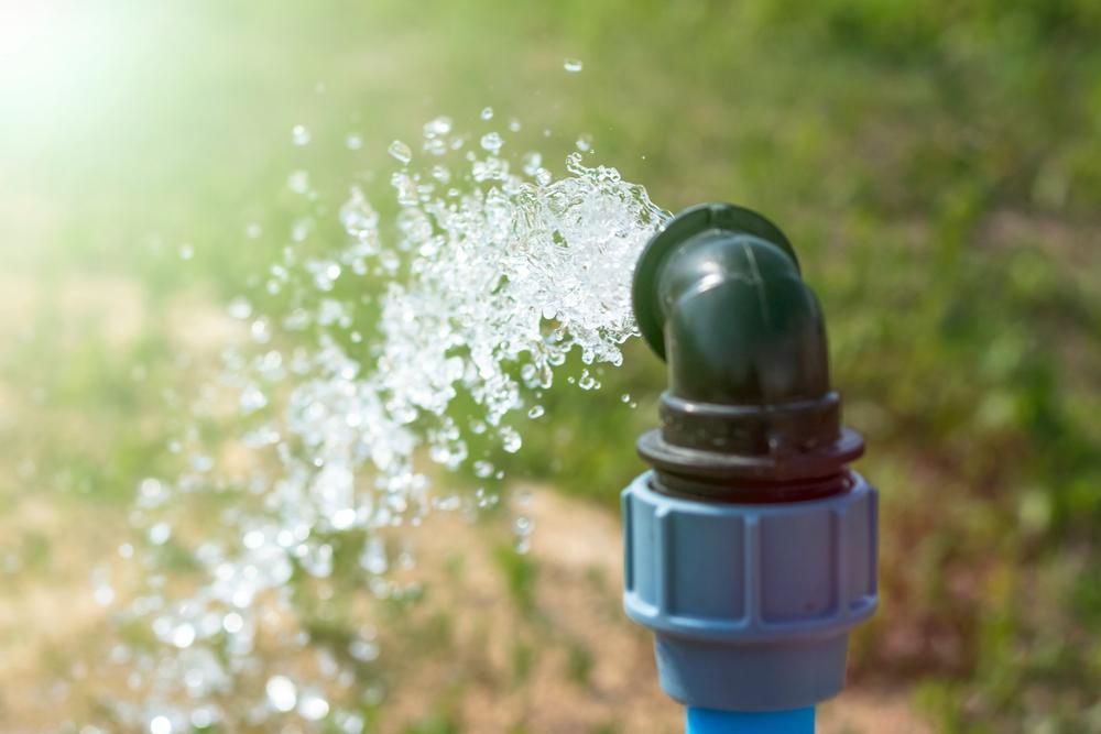 A Close Up Of A Water Pipe Spraying Water — Eureka Water & Filtration In Cairns, QLD