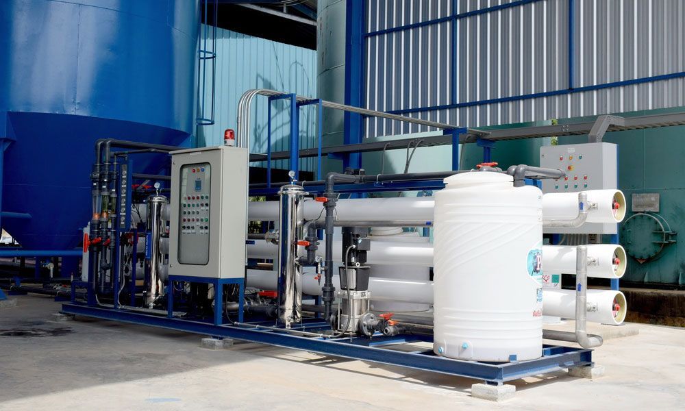 A Water Treatment Plant Is Sitting In Front Of A Building — Eureka Water & Filtration In Mount St John, QLD