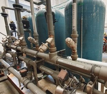 A Bunch Of Pipes Are Lined Up In A Room — Eureka Water & Filtration In Mount St John, QLD