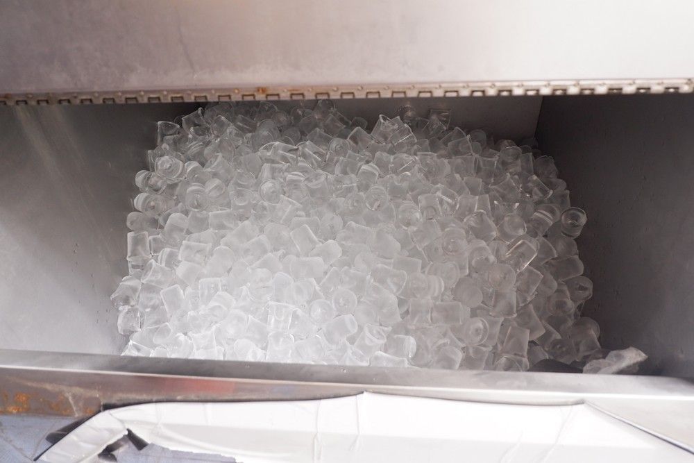 A Container Filled With Ice Cubes Is Sitting On A Table — Eureka Water & Filtration In Mount Isa, QLD