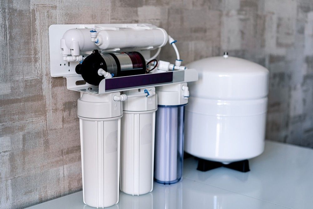 A Water Filter Is Sitting On A Table Next To A Wall — Eureka Water & Filtration In Cairns, QLD