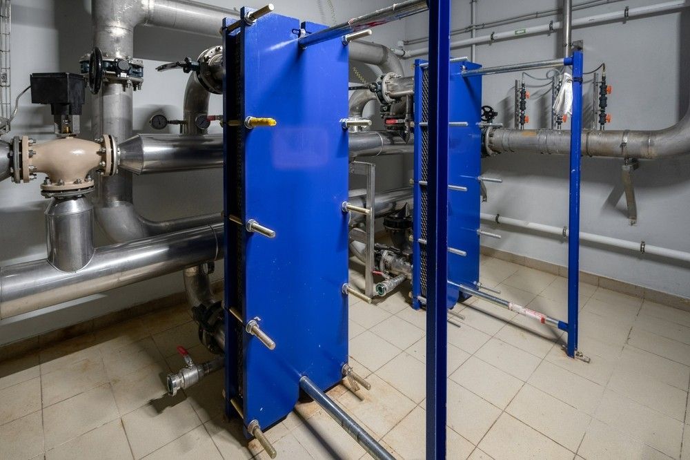 A Room Filled With Lots Of Pipes And Blue Plates — Eureka Water & Filtration In Mount Isa, QLD