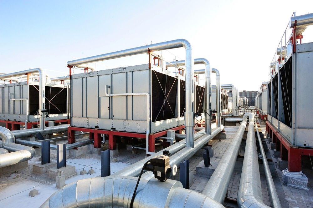 A Row Of Cooling Towers And Pipes On Top Of A Building — Eureka Water & Filtration In Cairns, QLD