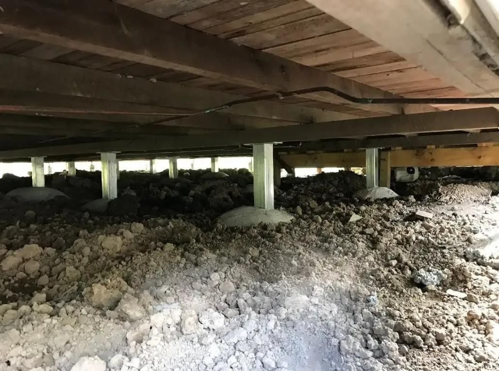 The Bottom of a Building With a Lot of Dirt Underneath It — Wilson's House Restumping in Goonellabah, NSW