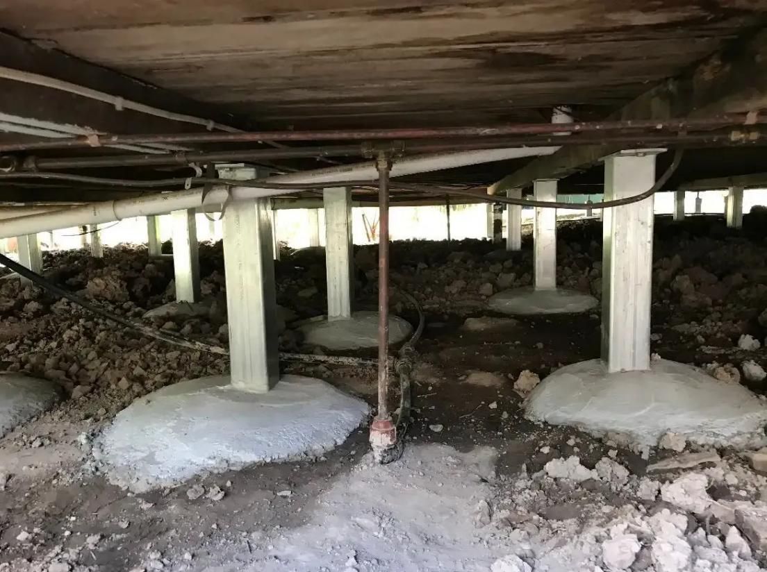 The Foundation of a House With Concrete Pillars and Pipes — Wilson's House Restumping in Mullumbimby, NSW