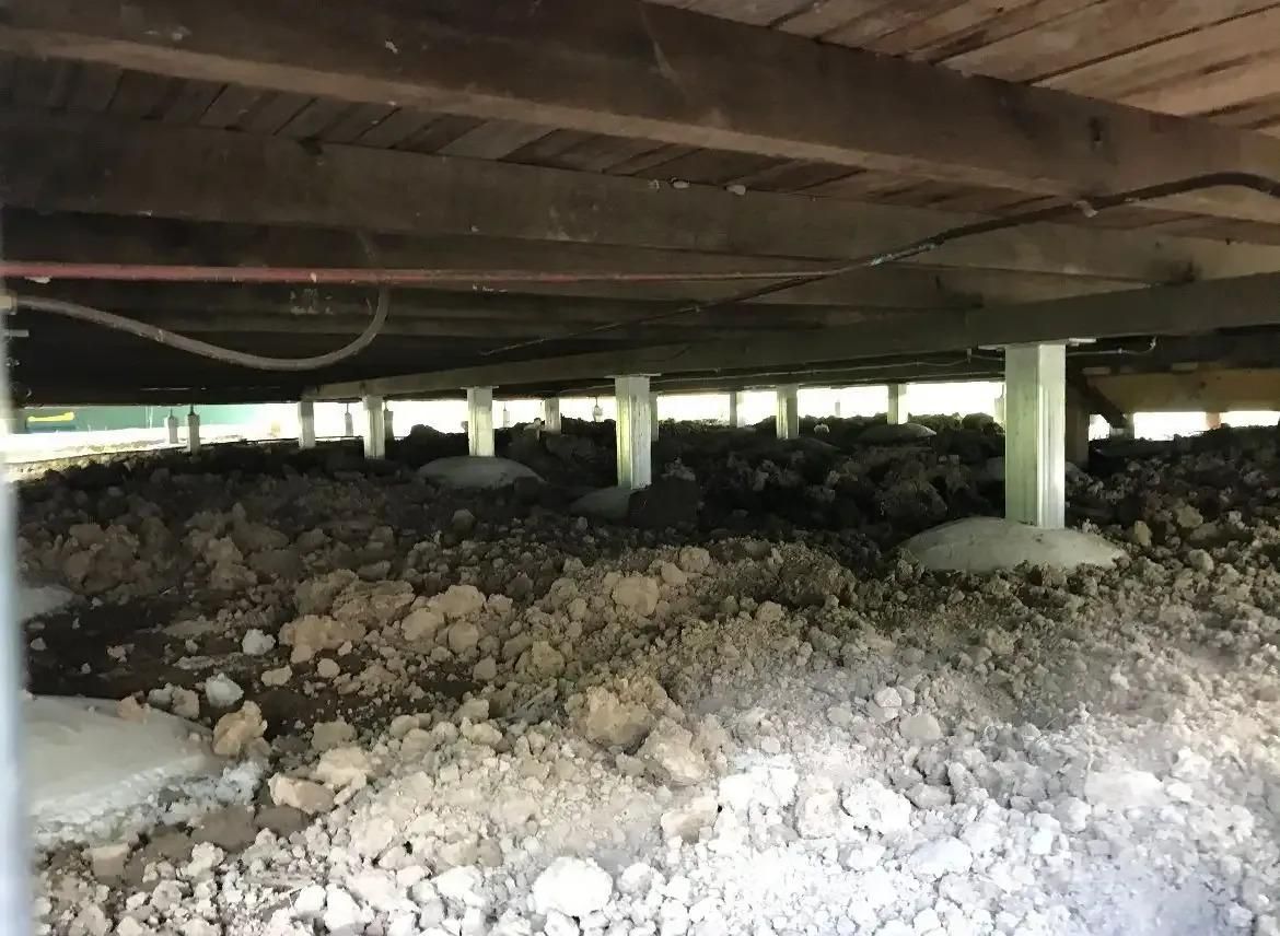 The Underside of a House With a Lot of Dirt and Rocks — Wilson's House Restumping in Goonellabah, NSW