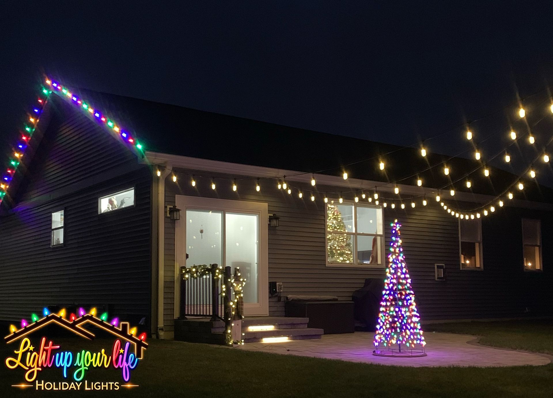 Edison Lighting, Commercial grade bistro patio lighting on a dimmer switch. with 2 Christmas trees in background. 