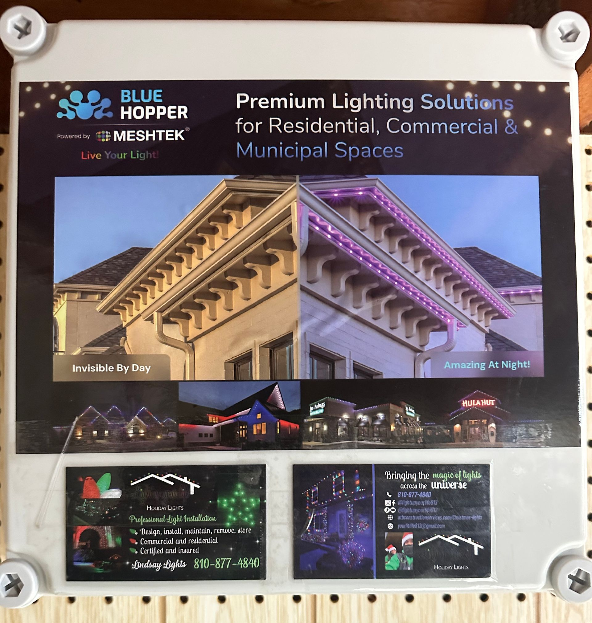 Light up your life holiday lights showing the outdoor control box that keeps all the lighting components and controllers safe from the weather. with their contact info on it for 24/7 customer support 
