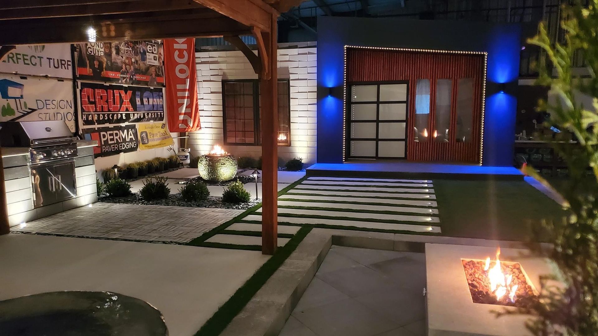 A fire pit in front of a sign that says perma paver edging. water and fire feature