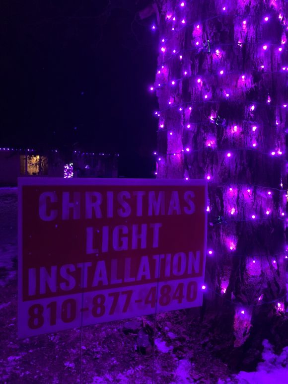 A sign that says christmas light installation on it