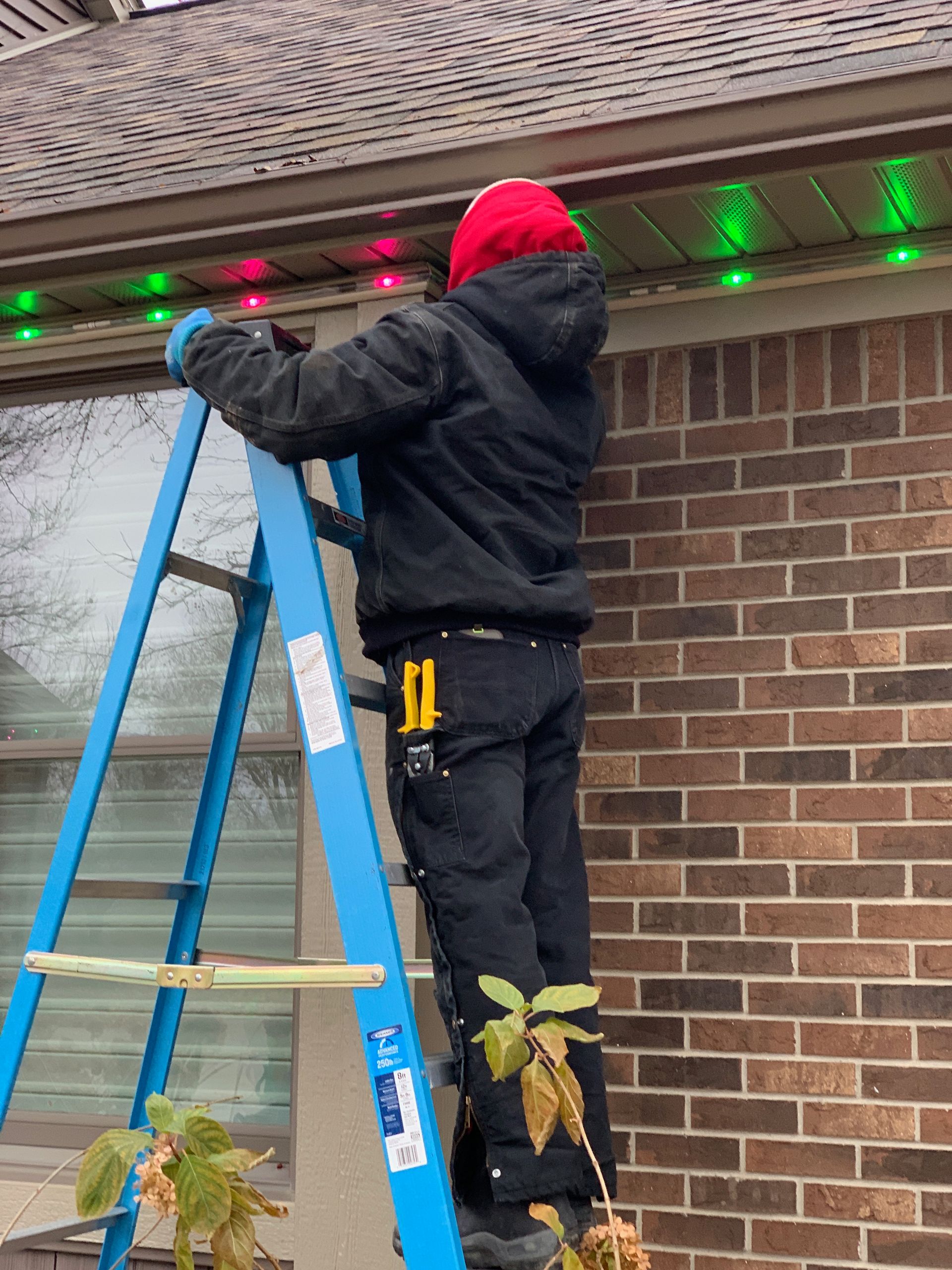 Authorized Bluehopper installer installing inception permanent lighting on a commercial building in Michigan. 