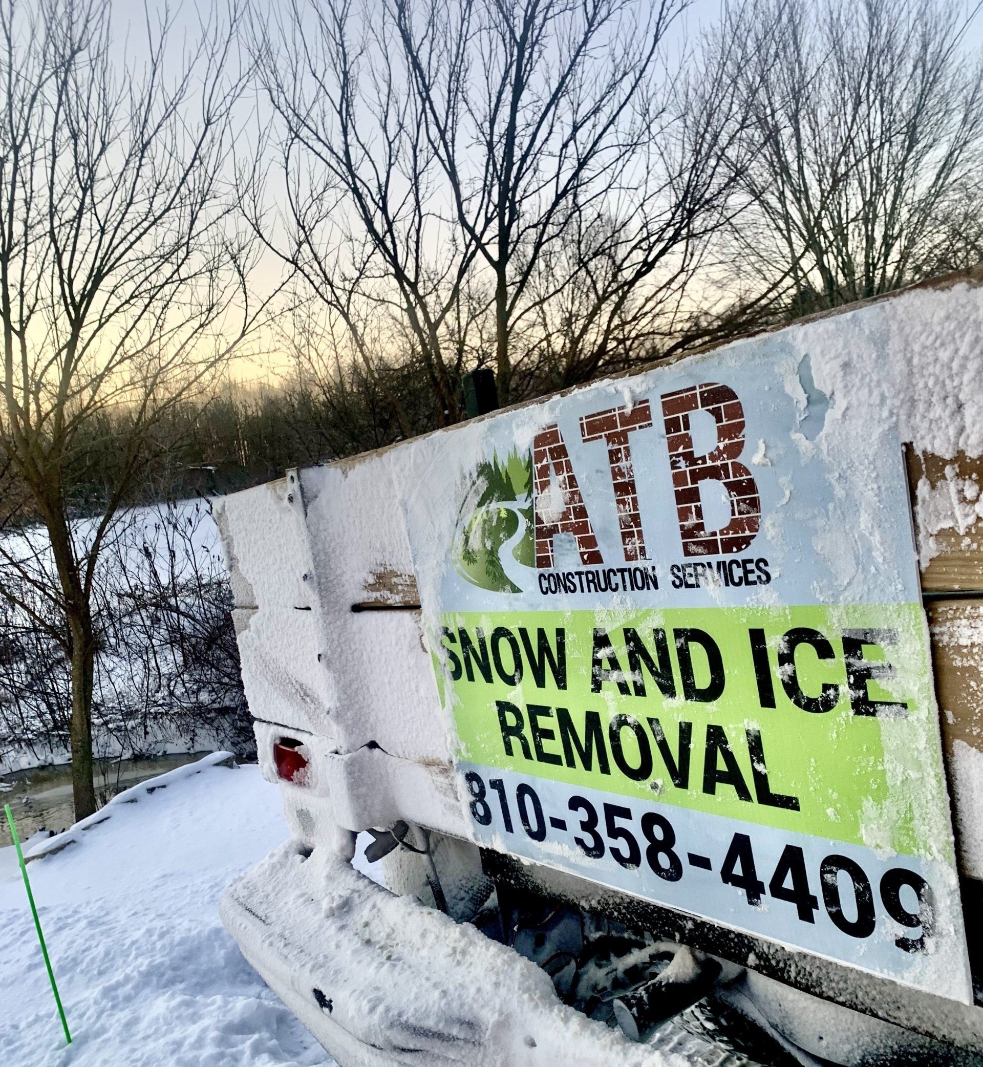 A snow and ice removal truck is parked in the snow.