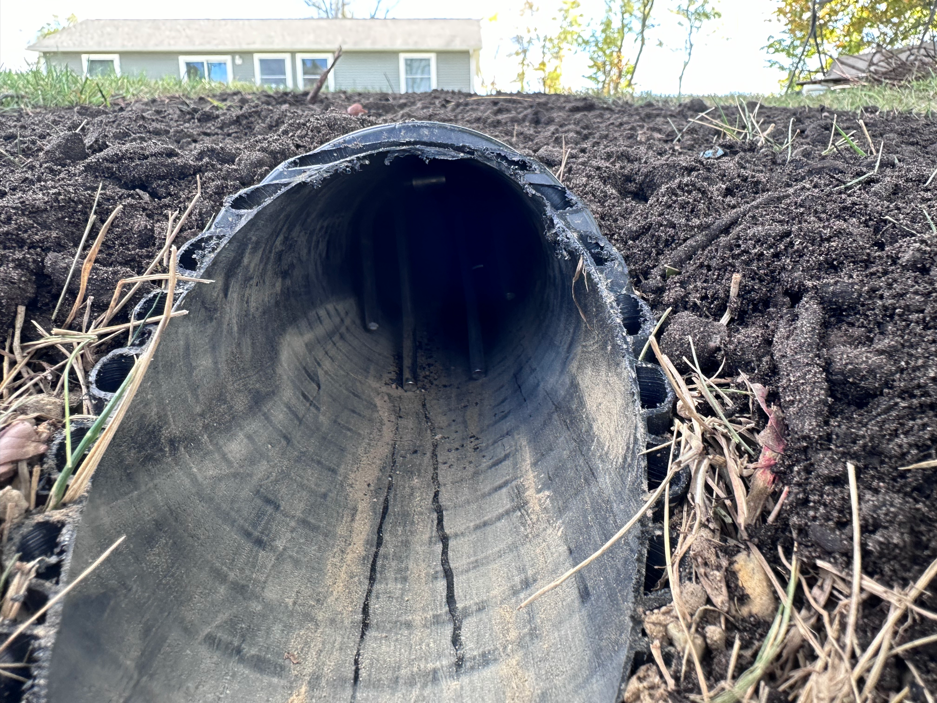 underground downspouts, drain tile, leaf filter, shingle gravel basin, french drain man, hdpe pipe, sump pump, trench.
