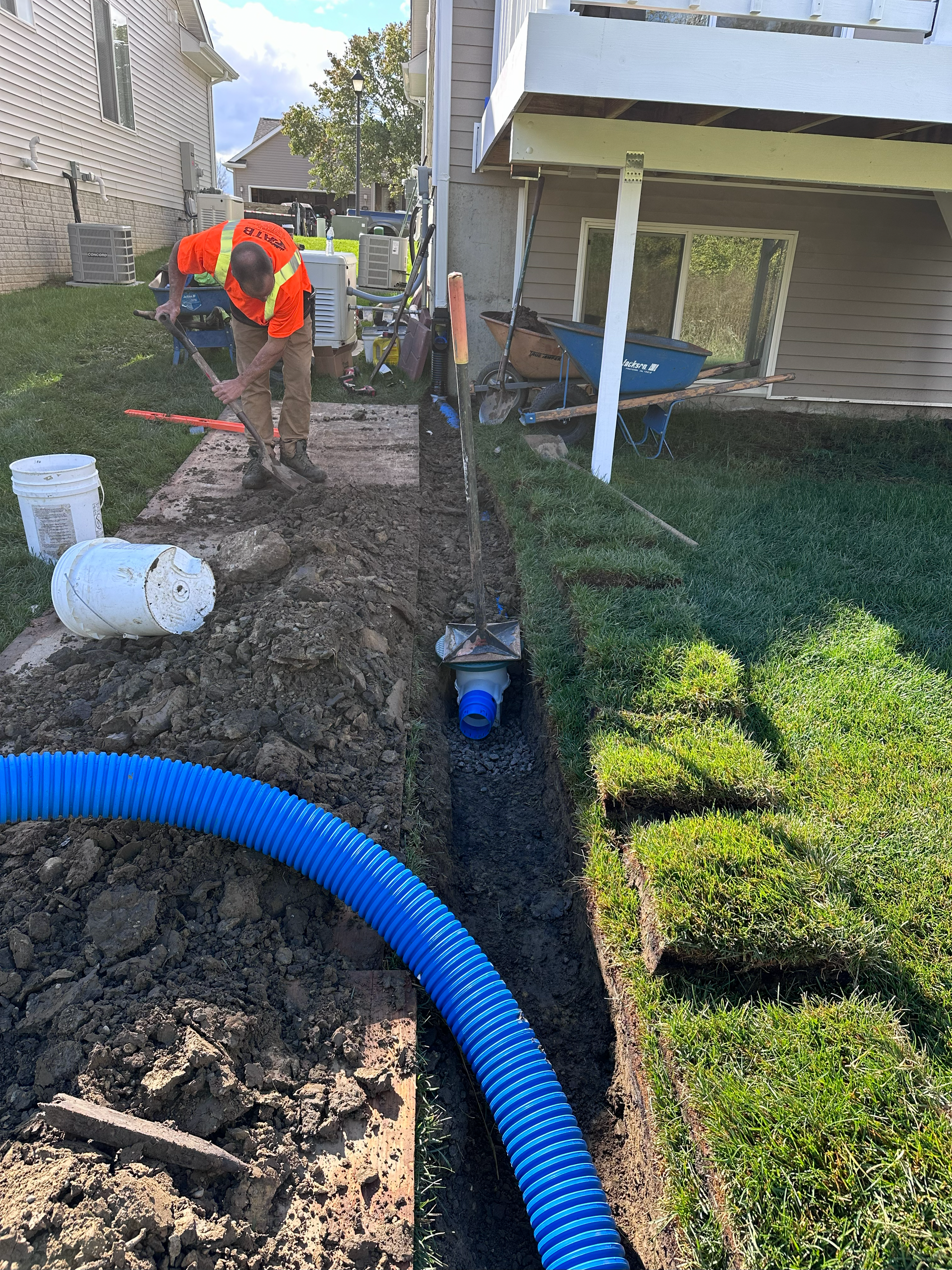 underground downspouts, drain tile, leaf filter, shingle gravel basin, french drain man, hdpe pipe, sump pump, trench.