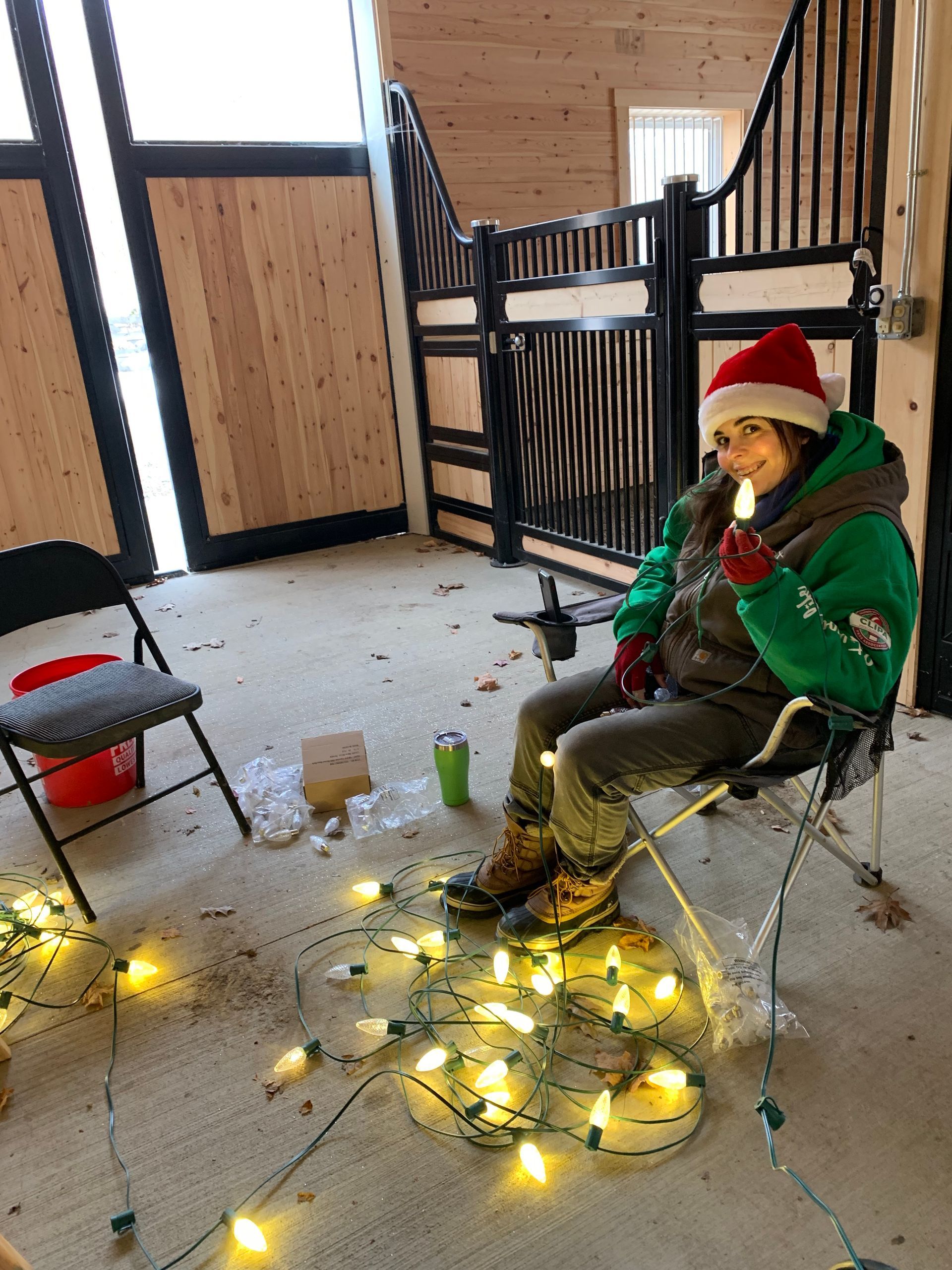 A room with tables , chairs , balloons and a christmas tree. lighting