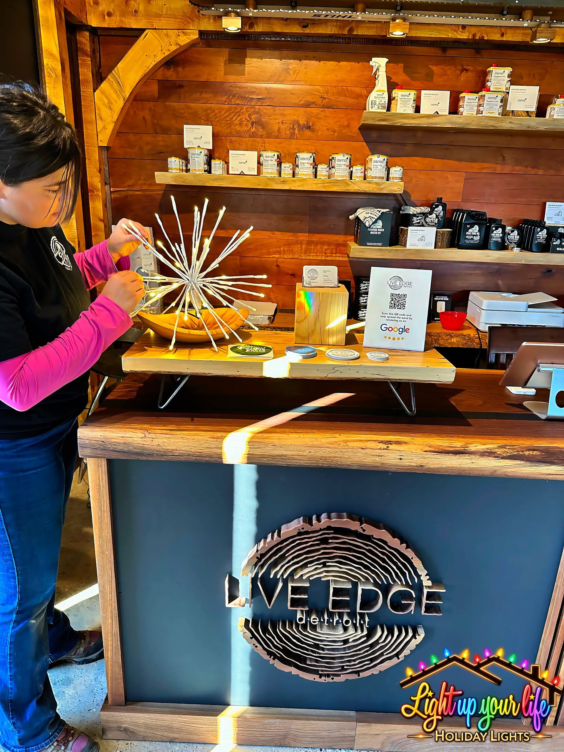 Spritzer at the front door of a commercial business in Detroit Michigan called live edge Detroit. warm white sparkling lights for an event. 