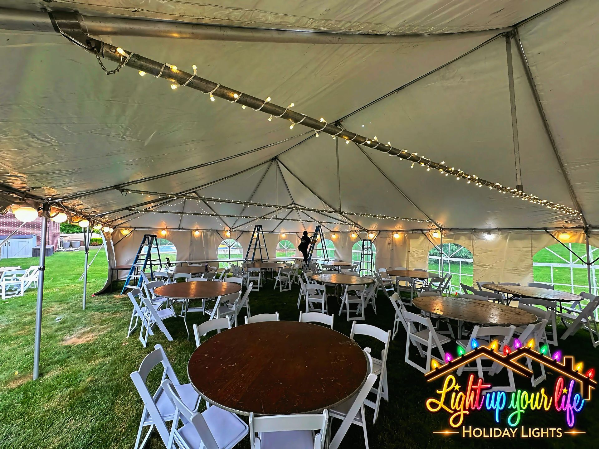 Commercial grade tent decorated with warm white mini lights for a wedding in michigan 