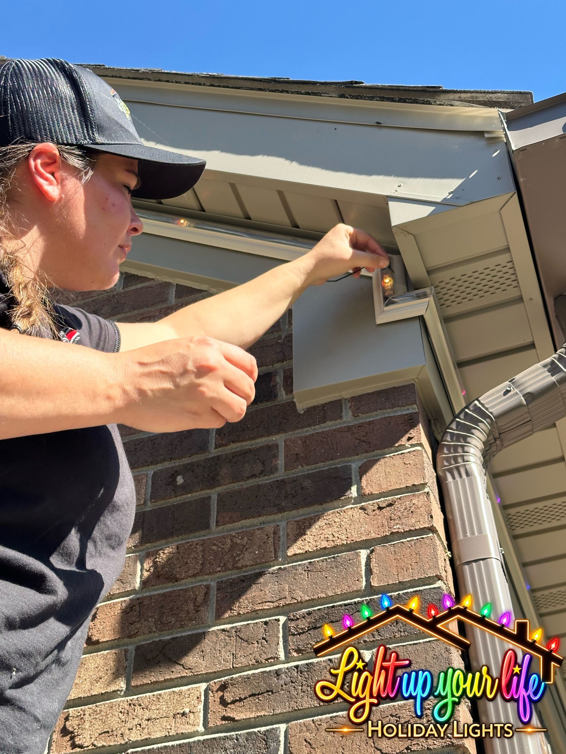 Professional Lighting installer making small adjustments to a permanent light project in michigan. all about the details. 
