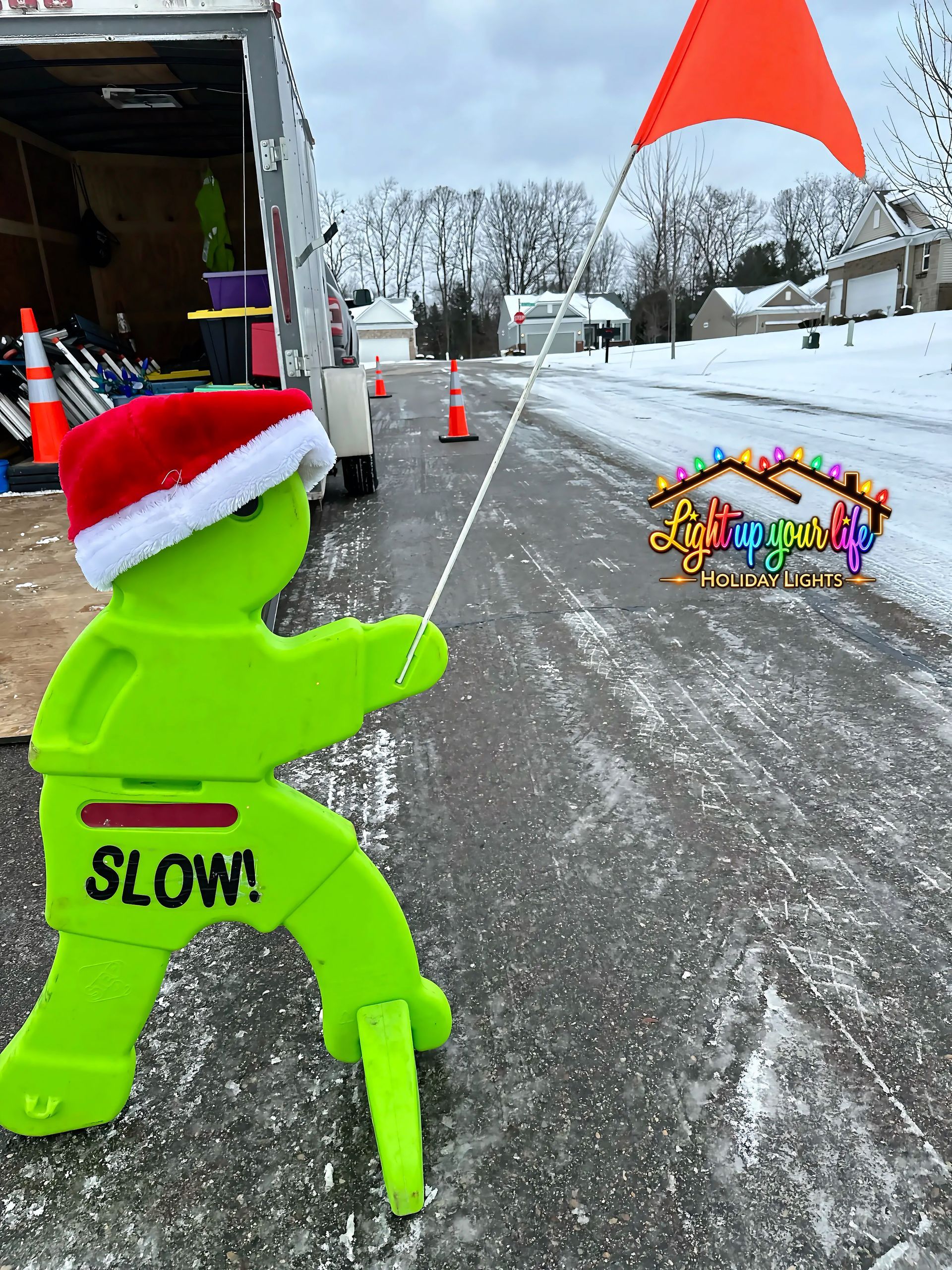 Safety Cones and safety turtle with a slow flag. Light up your life holiday lights is always thinking and working safely in Michigan. 