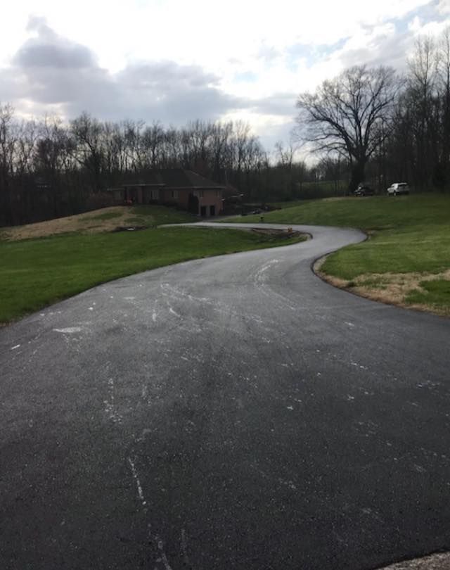 A road that is going through a grassy field