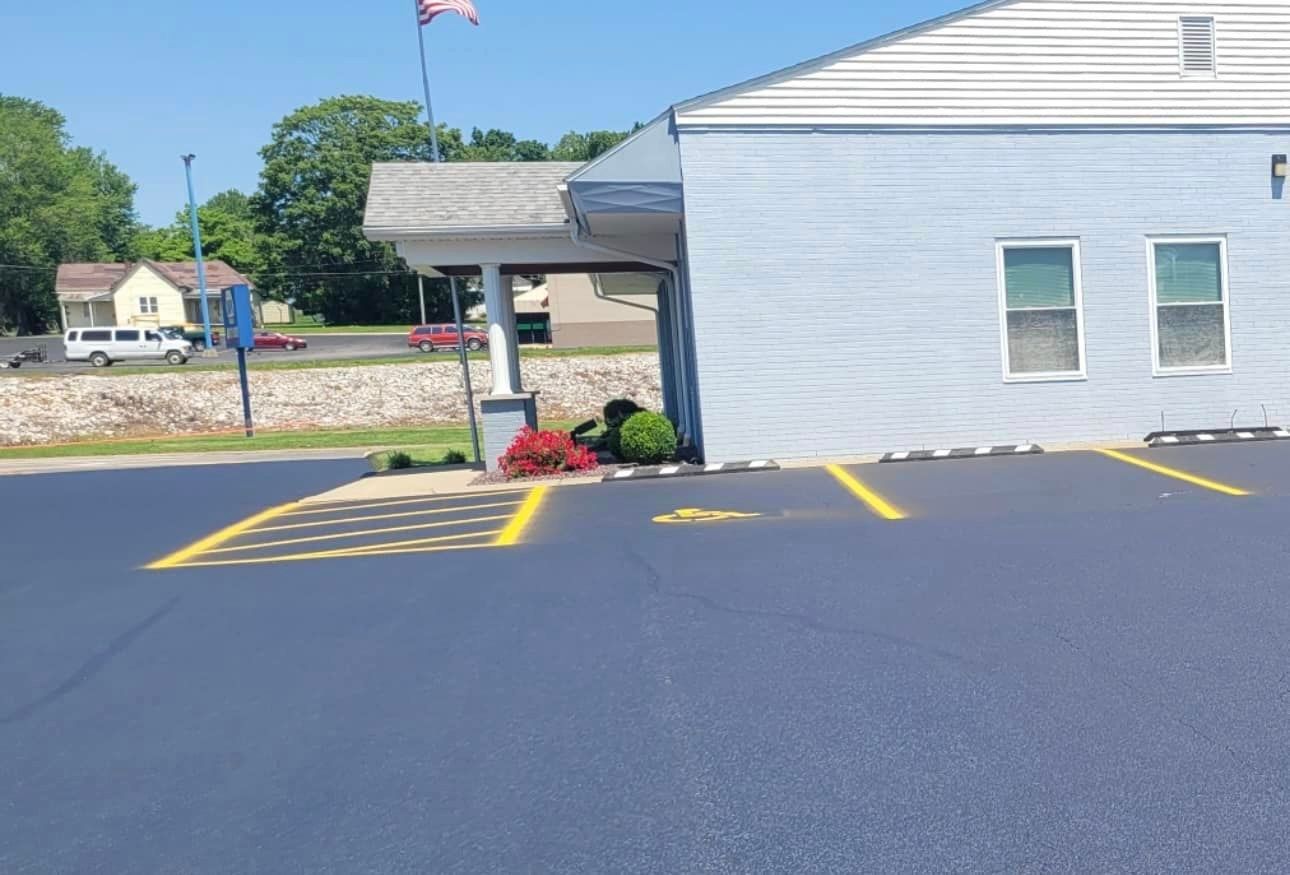 A white building with a handicapped parking spot in front of it.