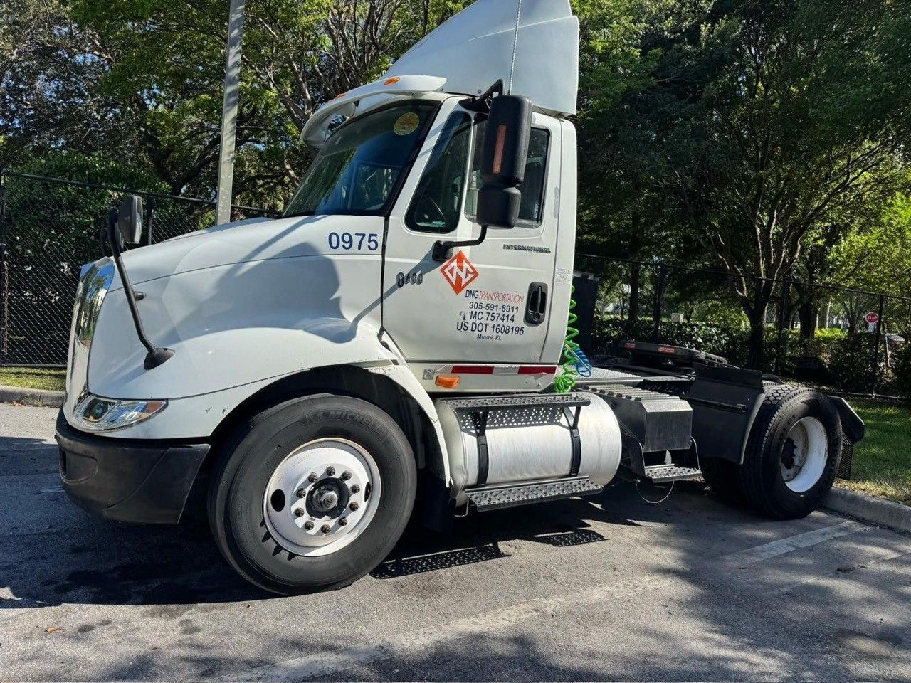 White semi-truck parked outdoors, with fuel tank and number 9975 on the side.