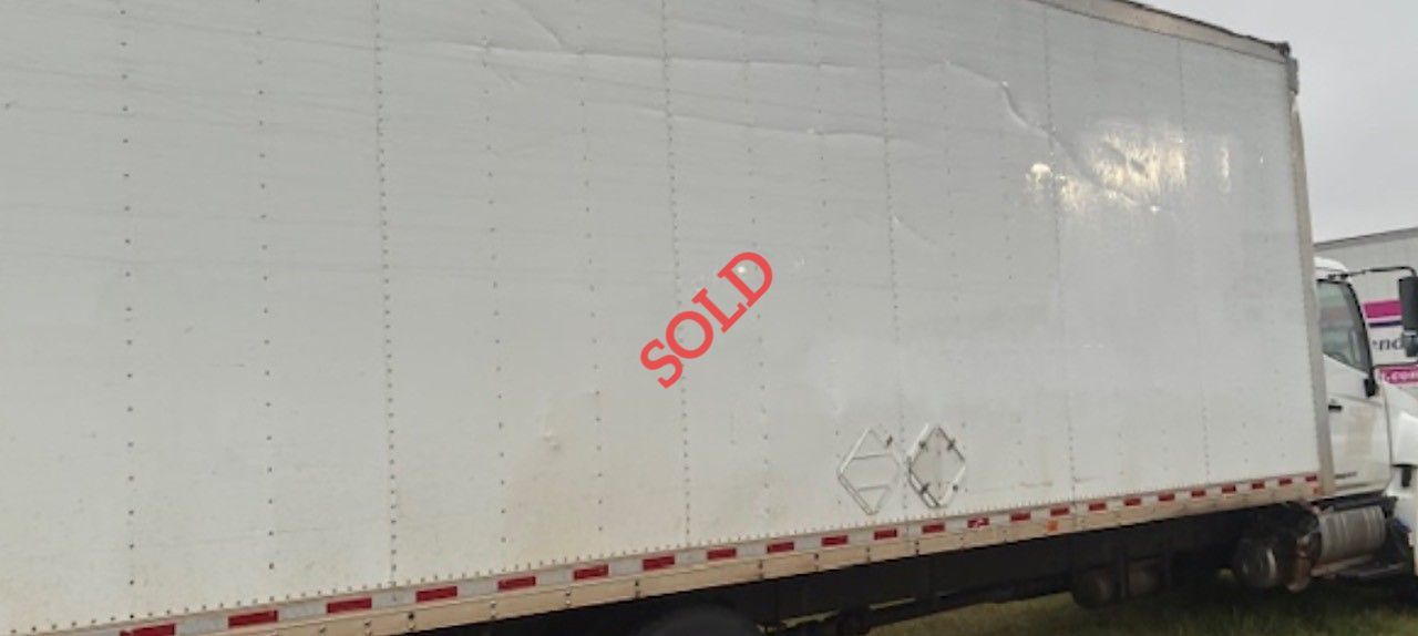 White semi-truck trailer with red 