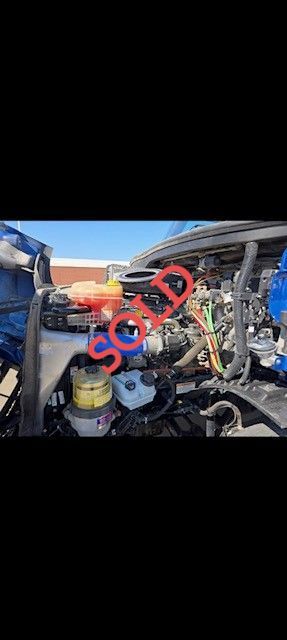 Engine compartment of a blue vehicle. Text 